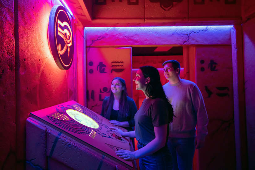 Three friends exploring the Wrath of Anubis Escape Room